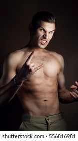 Aggressive young man posing, Studio portrait, man screaming, bare-chested, brutal man,