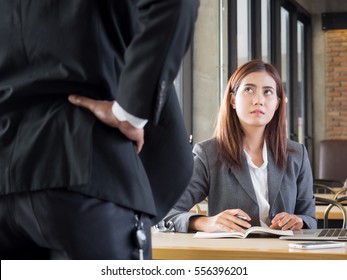 Aggressive/angry boss complaining asian business woman(casual uniform) in cafe office - Shutterstock ID 556396201