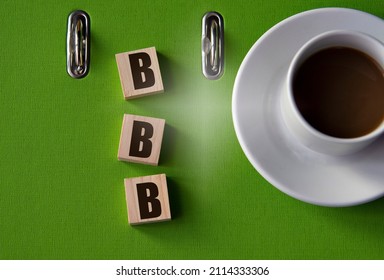 AGI- acronym on wooden cubes against the background of a green folder and a cup of coffee. Business and AGI adjusted gross income concept.