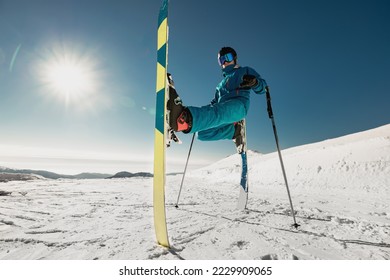 Agile young skier doing a trick while standing still. Ski resort - Shutterstock ID 2229909065