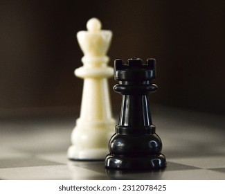 The agility of a white bishop against the resistance of a black rook in the chess battle. - Shutterstock ID 2312078425