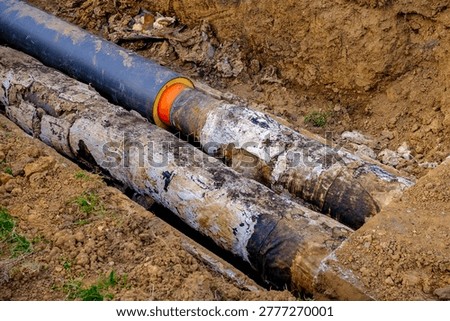 Aging heating infrastructure with worn underground pipes in excavated trench concept of outdated utility system