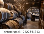 Aging process of cognac spirit in old dark French oak barrels in cellar in distillery house, Cognac white wine region, Charente, Segonzac, Grand Champagne, France