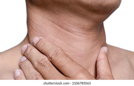 Aging skin folds or creases or wrinkles at neck of Southeast Asian, Chinese man. Concept of sore throat, pharyngitis or laryngitis.