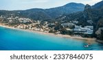 Agios Gordios exotic beach in Corfu island,Greece. Agios Gordios beach, Corfu island, Greece. Panoramic view of the Agios Gordios beach, sandy seashore with beach umbrellas and deck chairs.