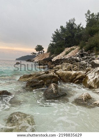 Agitated water at the seashore, and Through the marble rocks in a rainy summer day in a Greek island 
