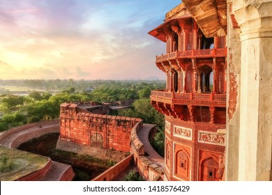 Agra Fort - Famous medieval historic fort exterior structure with view of Agra city landscape at sunrise