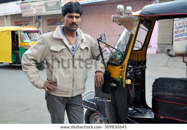 AGRA , INDIA - DECEMBER 27 :
Undefined driven take a photo with our auto rickshaw at Agra in the
northern state of Uttar Pradesh on December 27,2010 in Agra, India.
