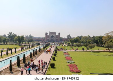 AGRA, INDIA - MARCH 7, 2019: Perspective view of the main gate of Taj Mahal from the main Taj Mahal with reflection in the water in Agra, India.
