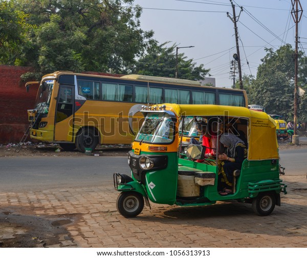Agra, India -\
Nov 12, 2017. Private auto rickshaw three-weeler tuk-tuk taxi\
drives down the street in Agra,\
India.