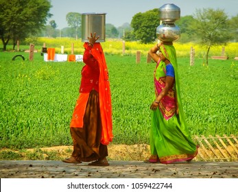 AGRA, INDIA-FEB 1: Unidentified Women Carry Metal Buckets On Their Heads In The Countryside On February 1,2011 Near Agra, India. Drinking Water Supply And Sanitation In India Continue To Be Inadequate