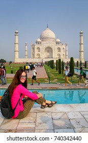AGRA, INDIA-NOVEMBER 9: Unidentified woman sits at  Taj Mahal complex on November 9, 2014 in Agra, India. Taj Mahal was designated as a UNESCO World Heritage Site in 1983.