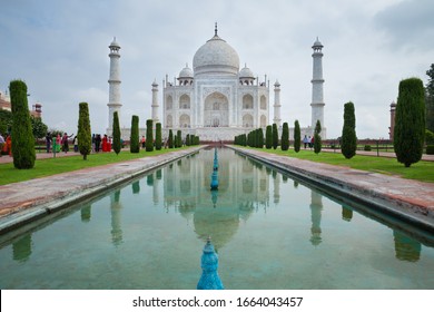 Agra, Uttar Pradesh, India- July, 2019: The view of symmetry Taj Mahal and reflection on central axis pool