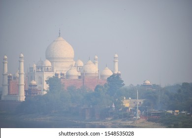 Agra, Uttar Pradesh, India - November 2018: Taj Mahal Through Smog Air Pollution In India, Impact Of Air Pollution On Taj Mahal Yamuna River Bank