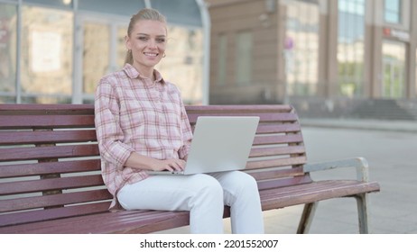 Agree Young Woman Shaking Head In Approval While Sitting On Bench Outdoor