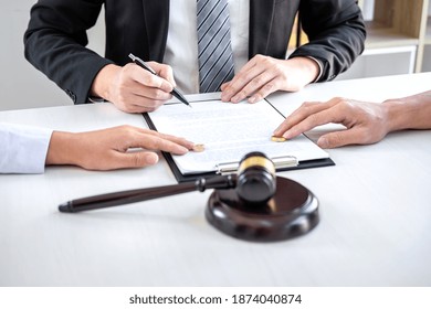 Agreement prepared by lawyer signing decree of divorce (dissolution or cancellation) of marriage, husband and wife during divorce process with male lawyer or counselor and signing of divorce contract. - Shutterstock ID 1874040874