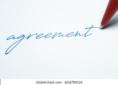 Agreement Written On Paper With A Red Ballpoint Pen