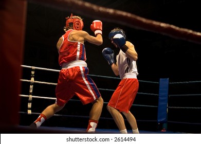 Agressive boxing fight, two boxers fighting on the ring
