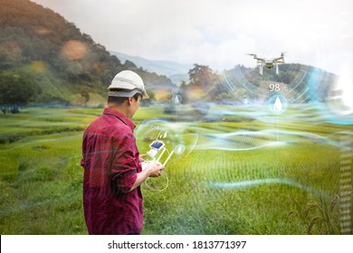 Agricultural engineering innovation modern technology Asian man farmer using drone flying scanning area for water level using controller mobile phone, in farm rice field mountain scenery background