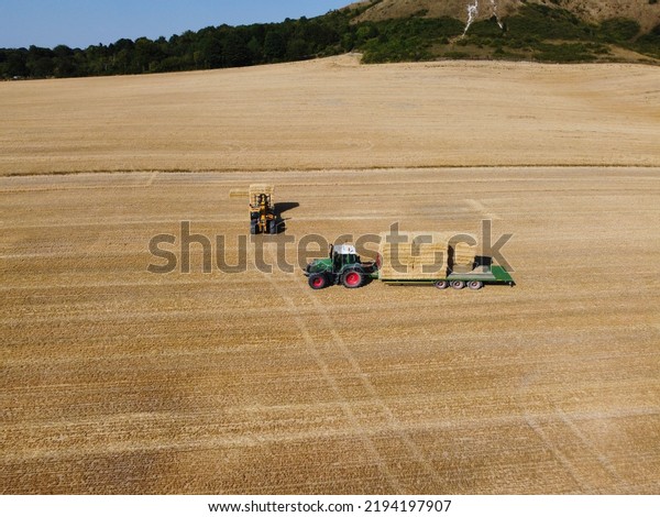 Agricultural Farms and Working Machines at\
Dunstable Downs England. High Angle Footage taken with drone\'s\
camera on a hot summer day of\
England