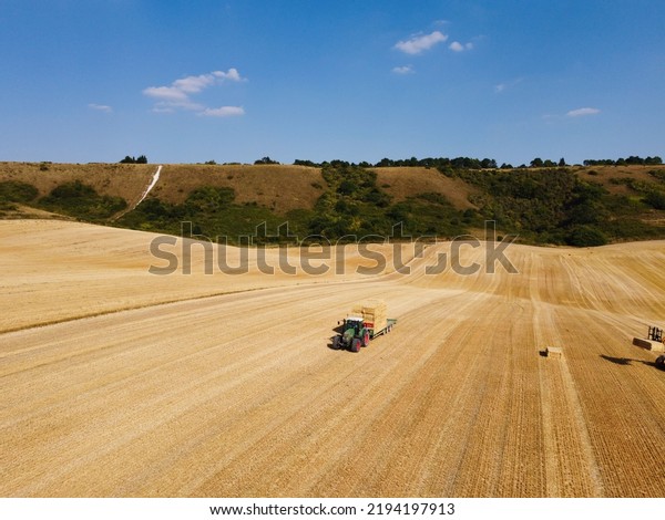 Agricultural Farms and Working Machines at
Dunstable Downs England. High Angle Footage taken with drone's
camera on a hot summer day of
England