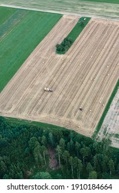 Agricultural Field With A Tractor On It From Above