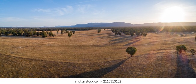 Agricultural Land With Mountains In The Background At Sunset - Aerial Panoramic Landscape