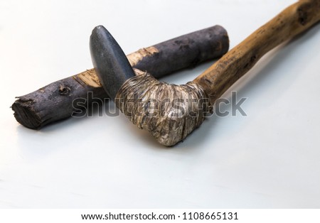 Agricultural lithic tool with wooden handle joint with tendon. Replica, Isolated over white background