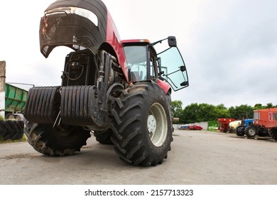 Agricultural Machinery Repair, Open Tractor Hood, Modern Engine, Tractor Maintenance.