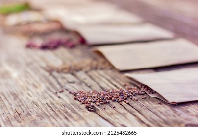 agricultural seeds in paper packs on a rustic wooden table, radish seeds in the foreground, selective focus. concept of farming, gardening, planting organic natural products.