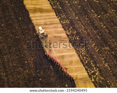 Similar – Image, Stock Photo Combine harvester harvests a grain field in the evening light from the air