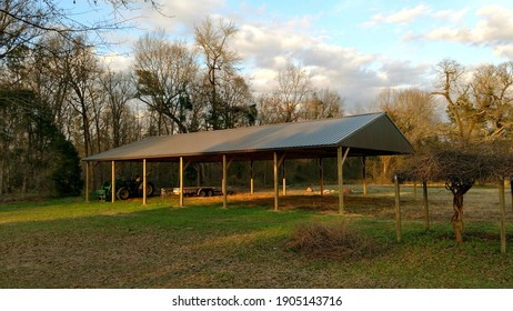 Agricultural Tractor Shed With Green Metal Roof And Green Metal End Walls With Space For Up To Six Pieces Of Farm Equipment