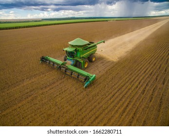 Agriculture - Correntina, Bahia, Brazil - April 27, 2019: Aerial Image Of Soybean Harvest, High Productivity, Machine Detail Harvesting Blue Sky - Agribusiness