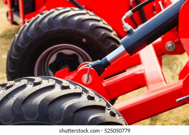 Agriculture Equipment Concept. Detailed Closeup Agricultural Machinery, Big Wheels With Tires. Outdoor Shot