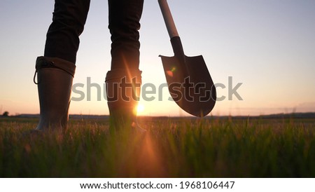 agriculture. farmer with a shovel walk in the field. agriculture business harvesting of a farmer man with shovel a walk to work in the field. business soil sun natural roducts harvest