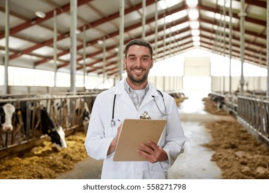 Agriculture Industry, Farming, People And Animal Husbandry Concept - Veterinarian Or Doctor With Clipboard And Herd Of Cows In Cowshed On Dairy Farm