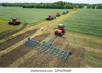 Agriculture machine harvesting crop in fields. Tractor pulls a mechanism for haymaking. Harvesting in autumn in the morning at dawn. agribusiness in the Altai region Russia. aerial view from above - Shutterstock ID 2294290689