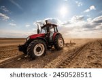 Agriculture machinery in action, a tractor plows a field on a bright day