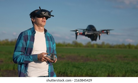 Agriculture. Man Farmer A Aerial Pilot Drone Survey Explorers Green Wheat Crops In The Field. Agriculture Modern Business Concept. Man Farmer Works In Field Crop. Drone Technology In Agriculture