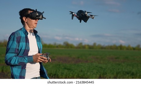 agriculture. man farmer a aerial pilot drone survey explorers green wheat crops in the field. agriculture modern business concept. man farmer works in field. drone agritech technology in agriculture