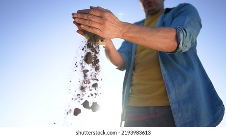 Agriculture. Top layer of soil in hands of the farmer. Fertile land in garden. The farmer touches the black fertile soil in field. A pile of brown earth in the hands of a man. Agriculture concept - Shutterstock ID 2193983613