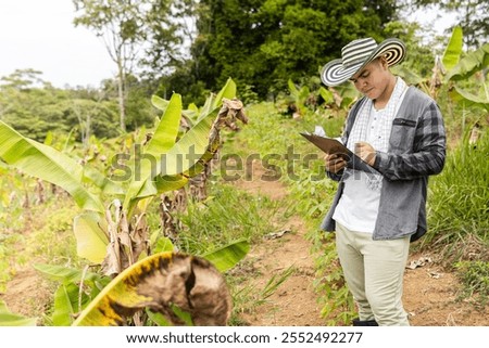 Agro-industrial engineer taking notes on a plantain plantation of a Colombian company