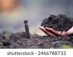 agronomist on a farm practicing agronomy holding soil, doing soil tests in her home laboratory. Looking at soil life and health and compost 