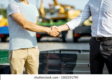 Agronomist Shaking Hand With Salesman, Buying A New Farm Truck Trailer At The Agricultural Shop, Close-up