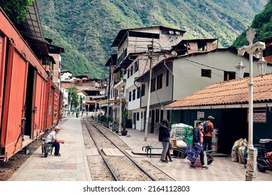 Aguas Calientes, Peru - January 05, 2022: People Unload A Freight Train Car.