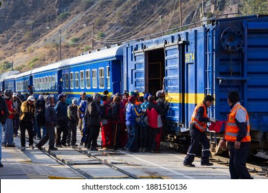 Aguas Calientes, Peru - June 24, 2015:  Workers Load Onto A Freight Car On A Peru Rail Train At The Aguas Calientes Stop Near Macho Picchu.