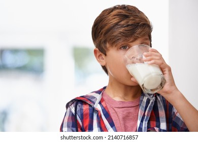 Ah... delicious. A young boy drinking a glass of milk. - Powered by Shutterstock