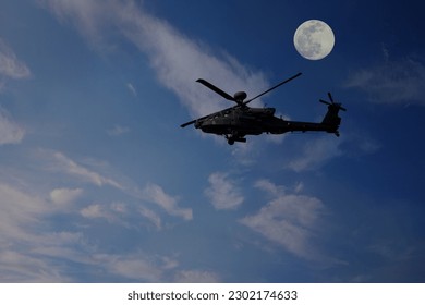 AH64 apache attack helicopter with moon background 