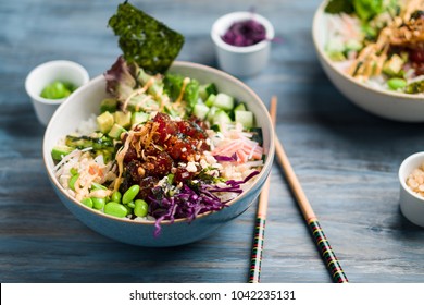 Ahi Tuna Poke Bowl Meal Horizontal View. Poke Is A Traditional Hawaiian Dish Influenced By Japanese And Asian Cuisine. Ahi Poke Is Made Of Raw Tuna Chunks Tossed Over Rice & Topped With Vegetables.