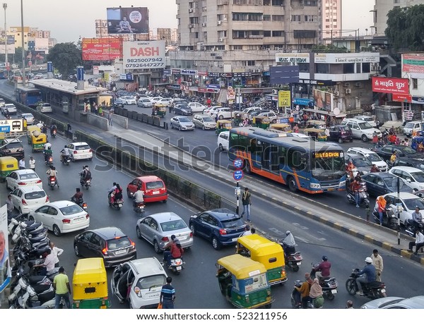 Ahmedabad, India - November 26, 2016:\
Light volume traffic scene in Ahmedabad. Auto rickshaws and Bus\
Rapid Transport (BRT) buses provide public\
transportation.